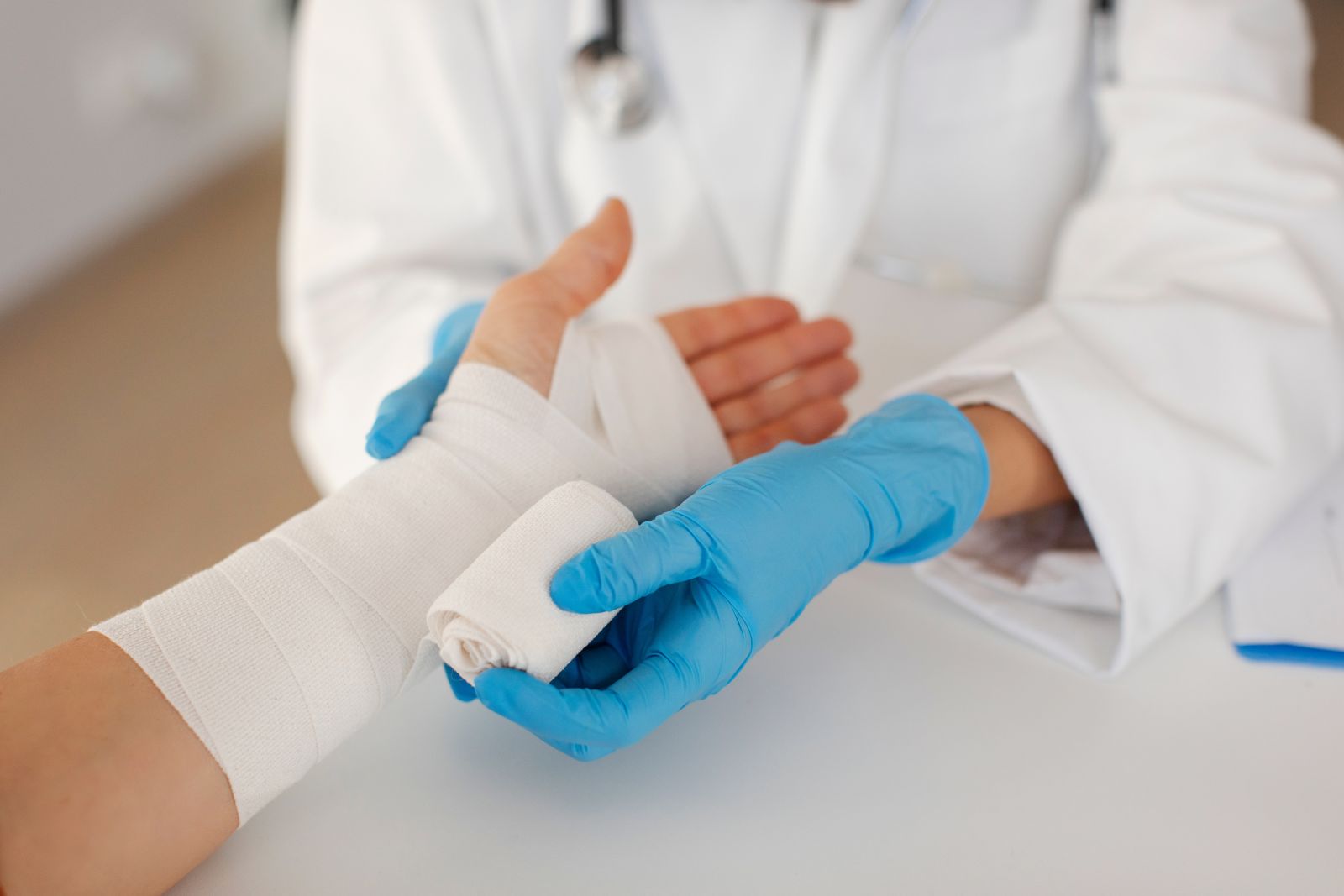 Image of doctor wrapping a hand in guaze